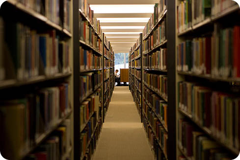 Looking through a library aisle